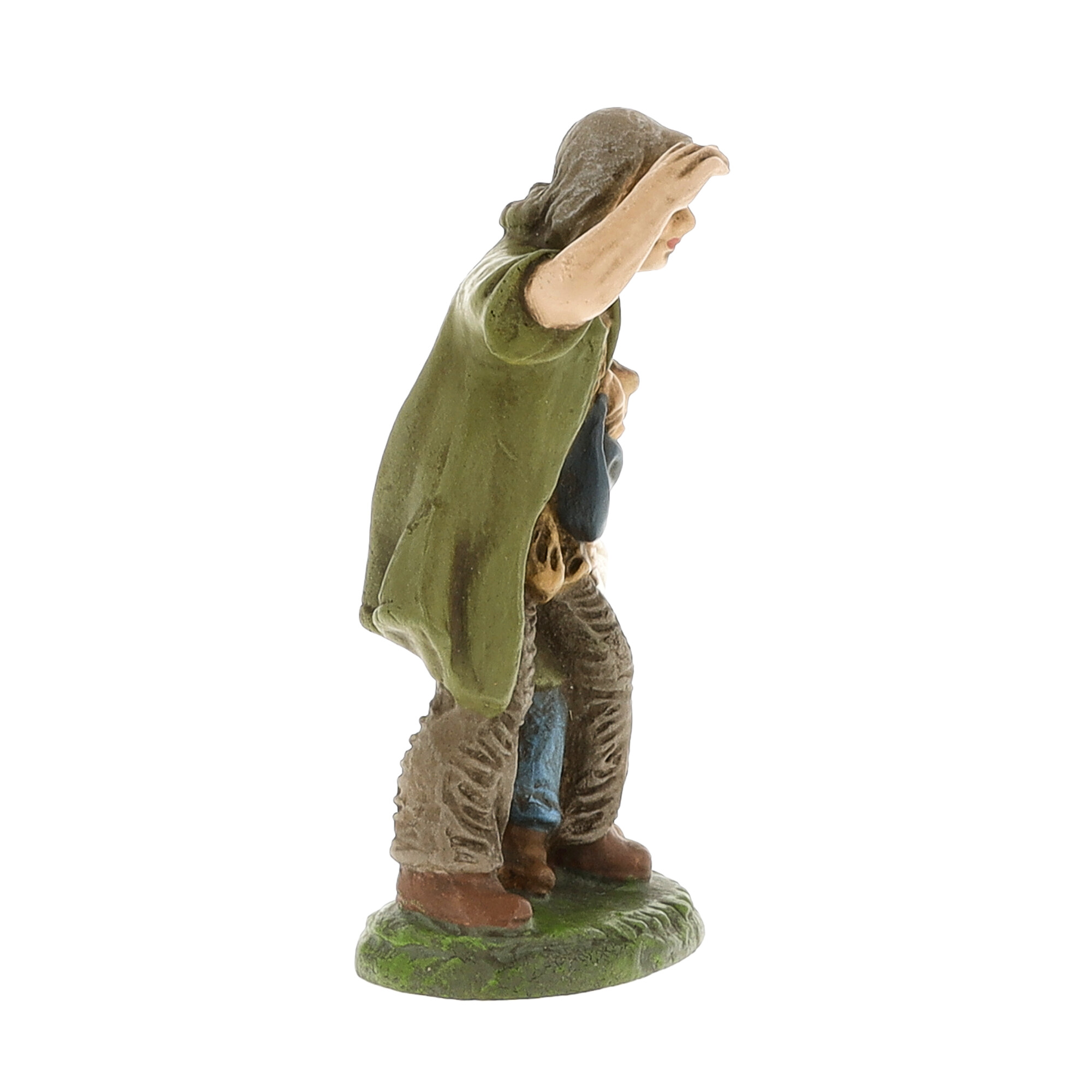 Handbemalte Krippenfigur: Mann hält Hand als Sichtschutz